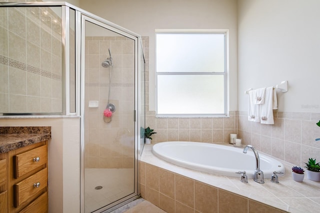 bathroom with vanity and separate shower and tub