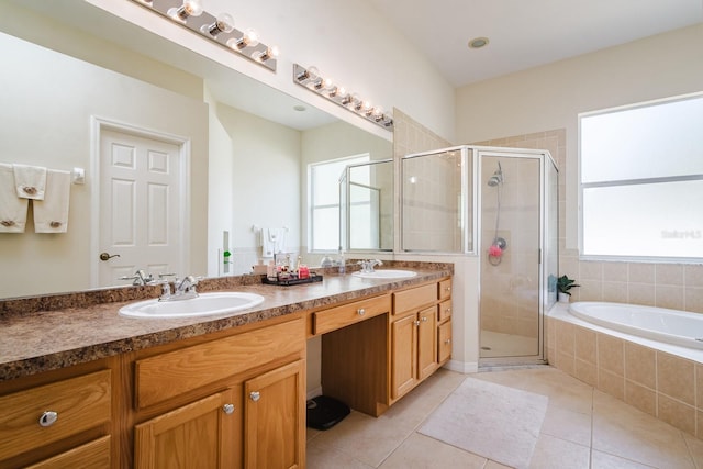 bathroom with plus walk in shower, vanity, tile patterned floors, and a healthy amount of sunlight