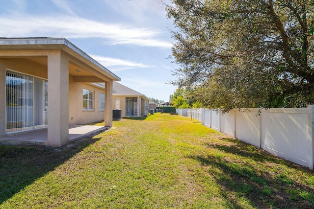 view of yard featuring cooling unit and a patio