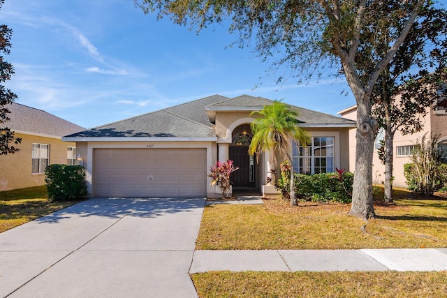 ranch-style home featuring a front yard and a garage