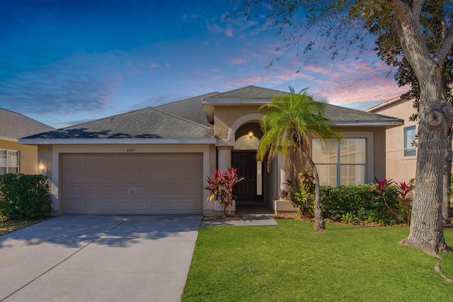 single story home with a lawn and a garage