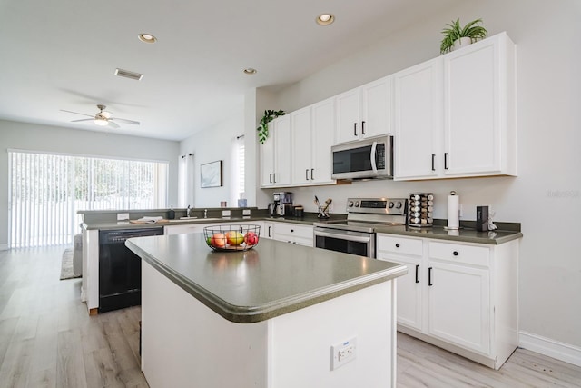 kitchen featuring a center island, stainless steel appliances, white cabinetry, and light hardwood / wood-style floors