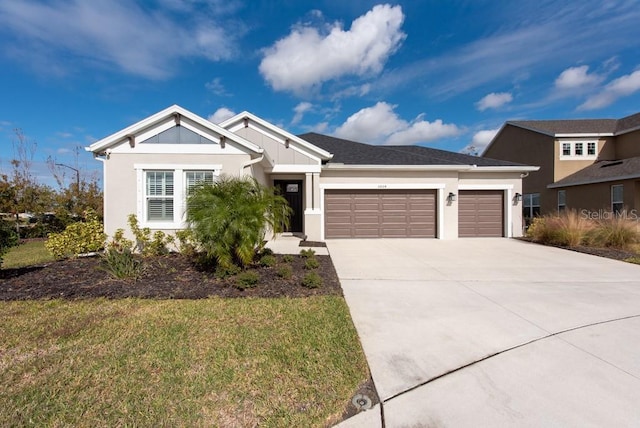 view of front of property with a front lawn and a garage