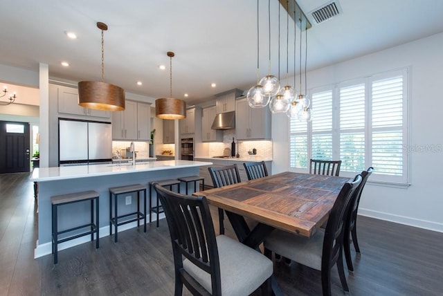 dining area with dark hardwood / wood-style flooring and sink