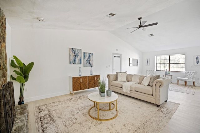 living room featuring ceiling fan, vaulted ceiling, and light wood-type flooring