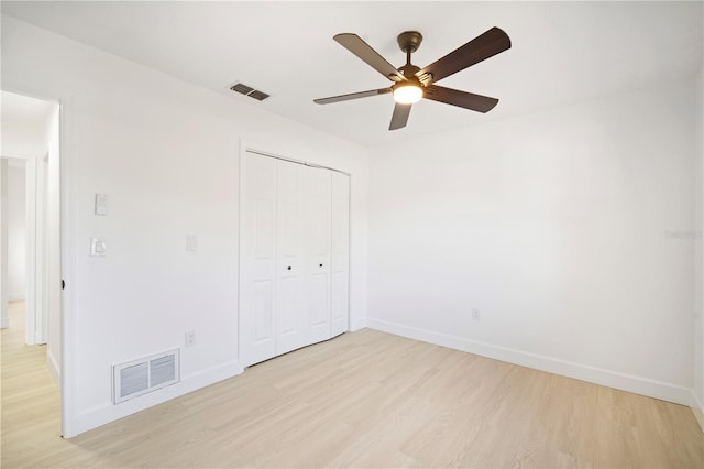 unfurnished bedroom with ceiling fan, a closet, and light hardwood / wood-style floors