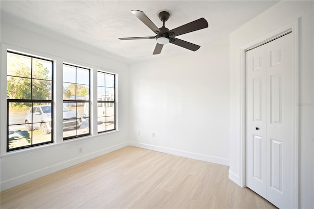 unfurnished room with ceiling fan and light wood-type flooring