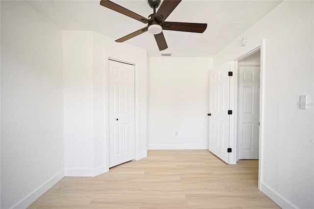 interior space with ceiling fan, a closet, and light hardwood / wood-style flooring