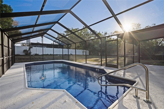 view of swimming pool featuring a patio area and a lanai