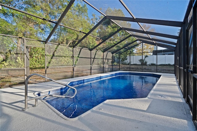 view of pool with a lanai and a patio