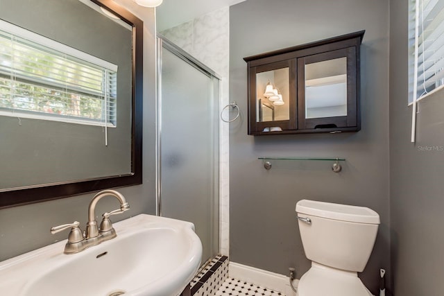 bathroom featuring toilet, tile patterned floors, a shower with door, and sink