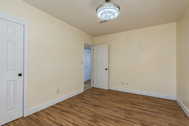 spare room with hardwood / wood-style floors