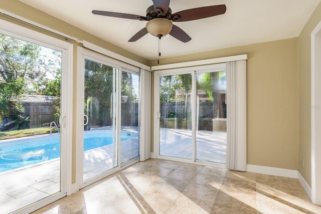 doorway featuring ceiling fan