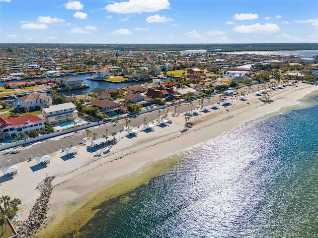 bird's eye view with a water view and a beach view