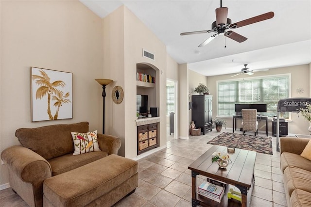 tiled living room featuring ceiling fan and built in features