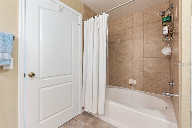 bathroom featuring tile patterned flooring and shower / tub combo