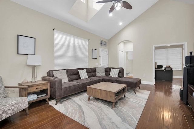 living room with ceiling fan, high vaulted ceiling, and dark wood-type flooring