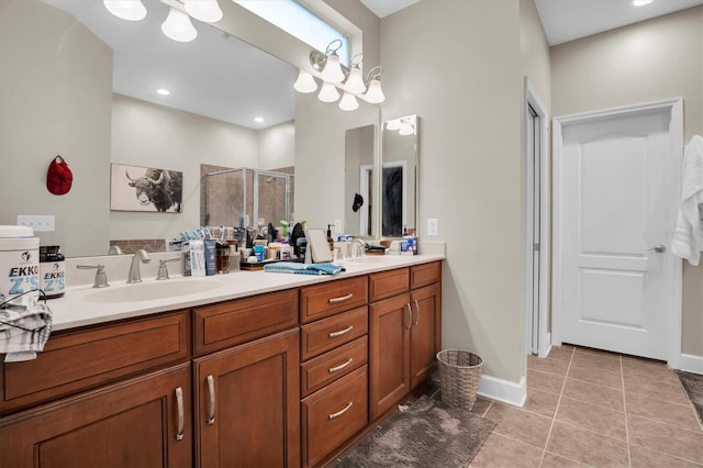 bathroom with tile patterned flooring, vanity, and a shower with shower door