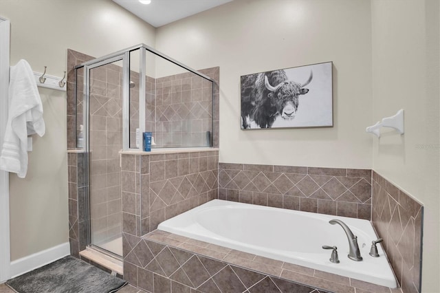 bathroom featuring separate shower and tub