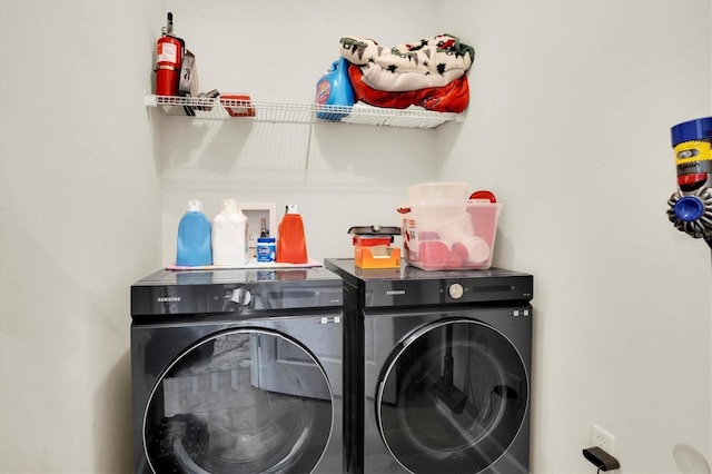 laundry room featuring washing machine and clothes dryer