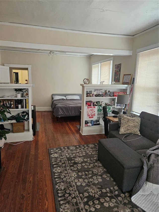 bedroom with dark hardwood / wood-style floors and crown molding