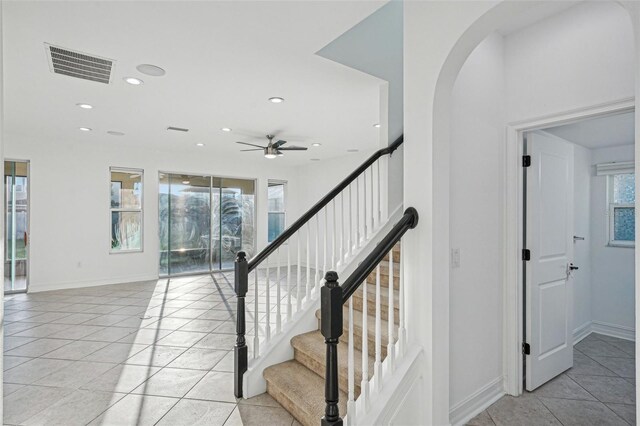 stairway with tile patterned flooring and ceiling fan