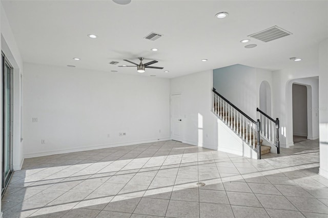 empty room with light tile patterned floors and ceiling fan