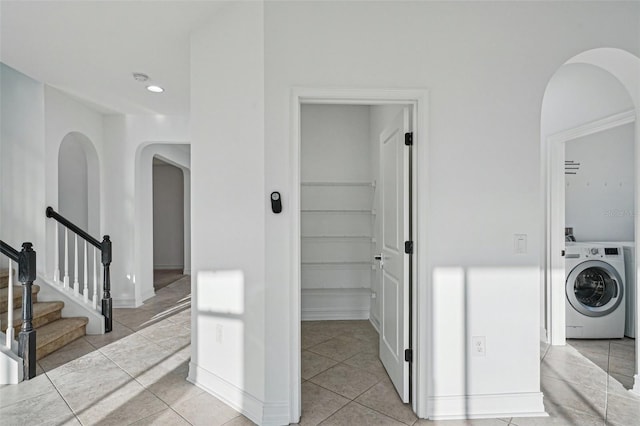 interior space with washer / dryer and light tile patterned floors