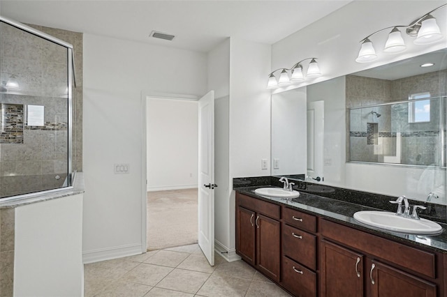 bathroom featuring vanity, tile patterned floors, and an enclosed shower