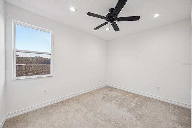 unfurnished room with ceiling fan and light carpet