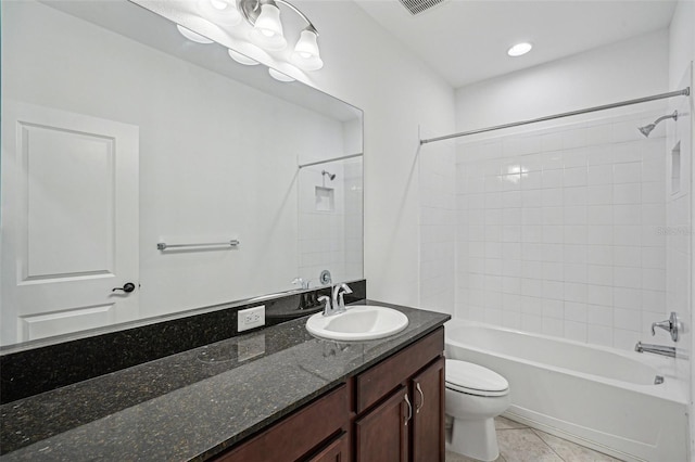 full bathroom with toilet, vanity, tile patterned floors, and tiled shower / bath combo