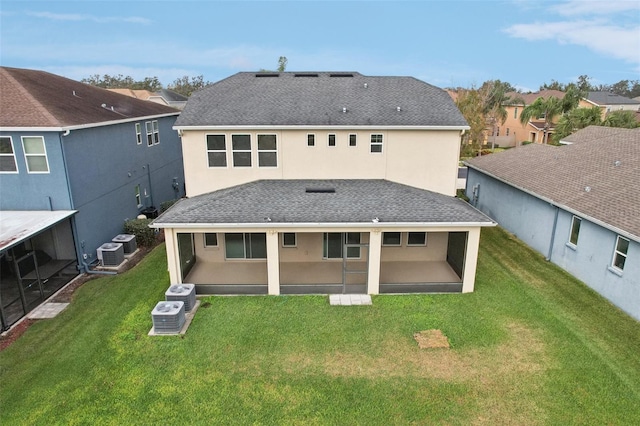 back of property with a patio, a lawn, and central air condition unit