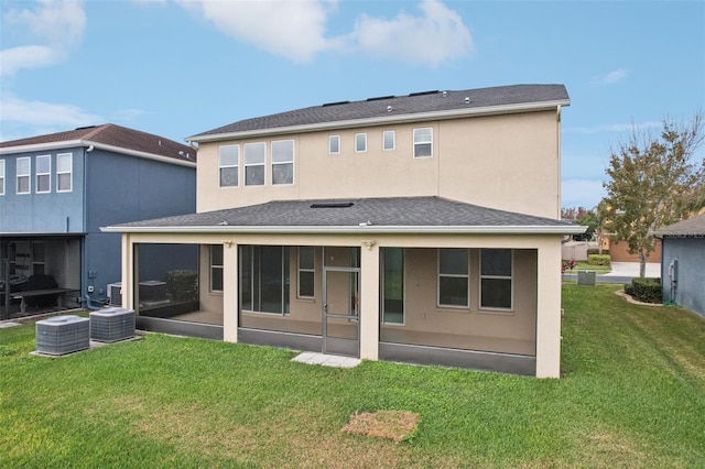 back of house featuring a sunroom, a yard, and cooling unit