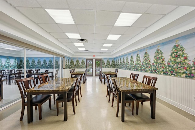 dining area featuring a drop ceiling