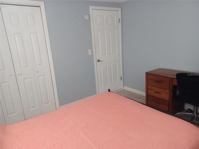 bedroom featuring a closet and light tile patterned flooring