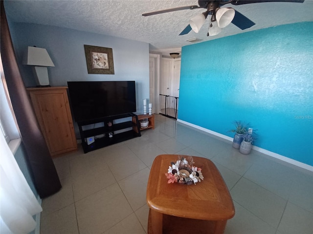 living room with tile patterned flooring and a textured ceiling