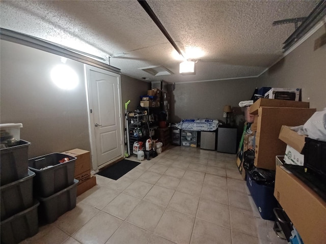 basement featuring light tile patterned flooring and a textured ceiling