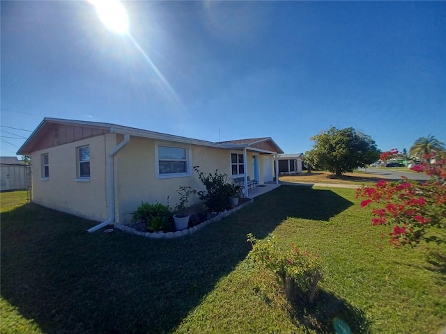 view of side of home featuring a lawn