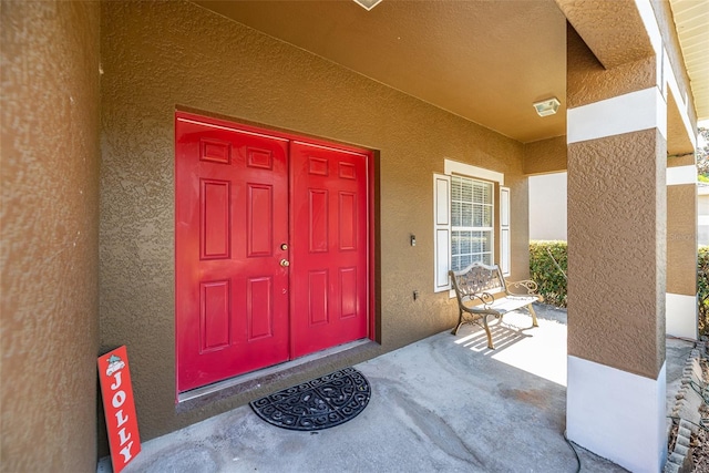 doorway to property with a porch