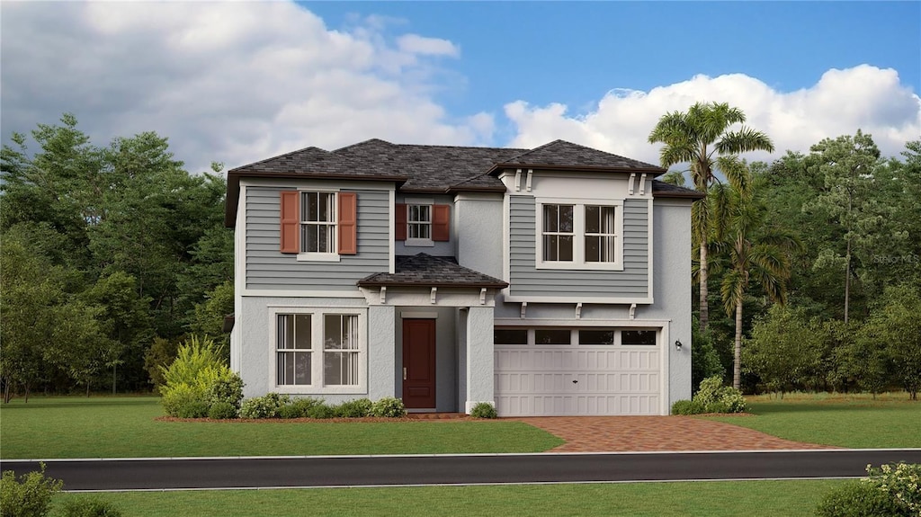 view of front of property with a garage and a front lawn