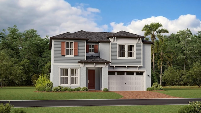 view of front of property with a garage and a front lawn