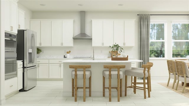 kitchen with white cabinets, wall chimney exhaust hood, stainless steel fridge with ice dispenser, and an island with sink