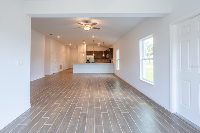 unfurnished living room with ceiling fan and lofted ceiling