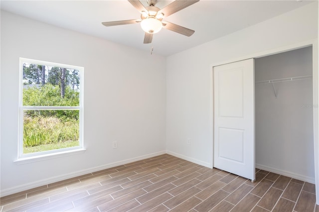 unfurnished bedroom with hardwood / wood-style floors, a closet, and ceiling fan