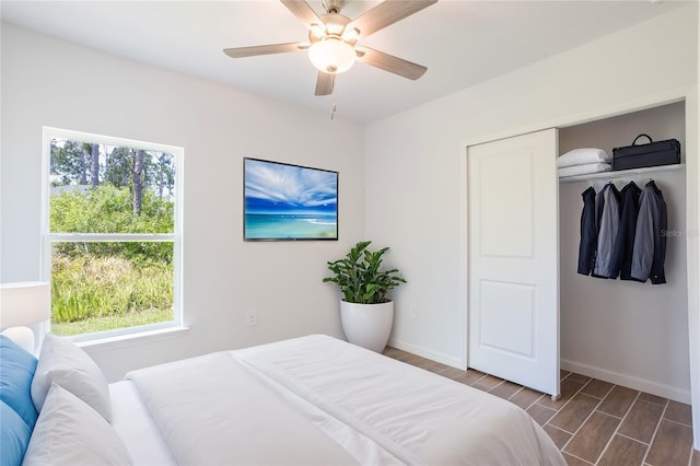 bedroom featuring ceiling fan and a closet