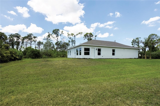 rear view of property with a yard