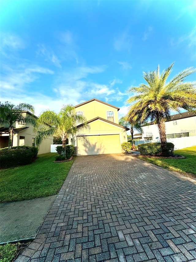 view of front of house featuring a garage and a front lawn