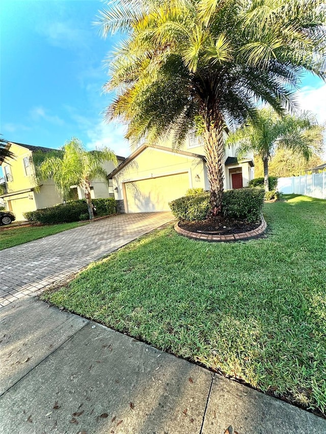 view of front facade featuring a front yard and a garage