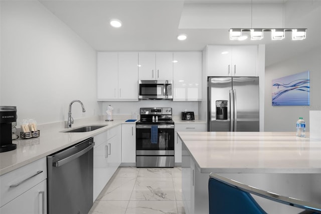 kitchen featuring sink, white cabinetry, light stone countertops, and appliances with stainless steel finishes