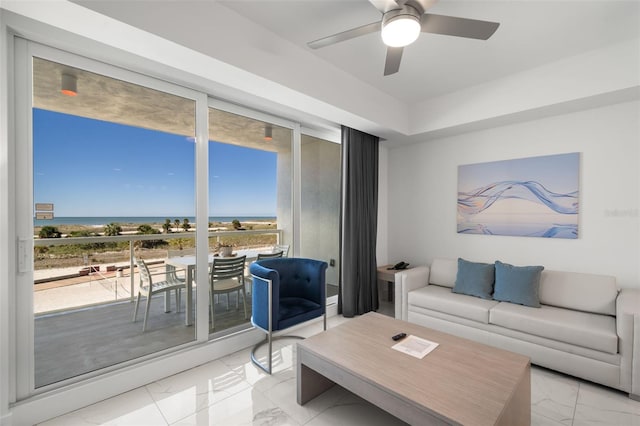 living room with a healthy amount of sunlight, a water view, and expansive windows